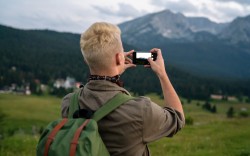 young man with backpack taking a photo on the top 2021 08 28 22 15 48 utc
